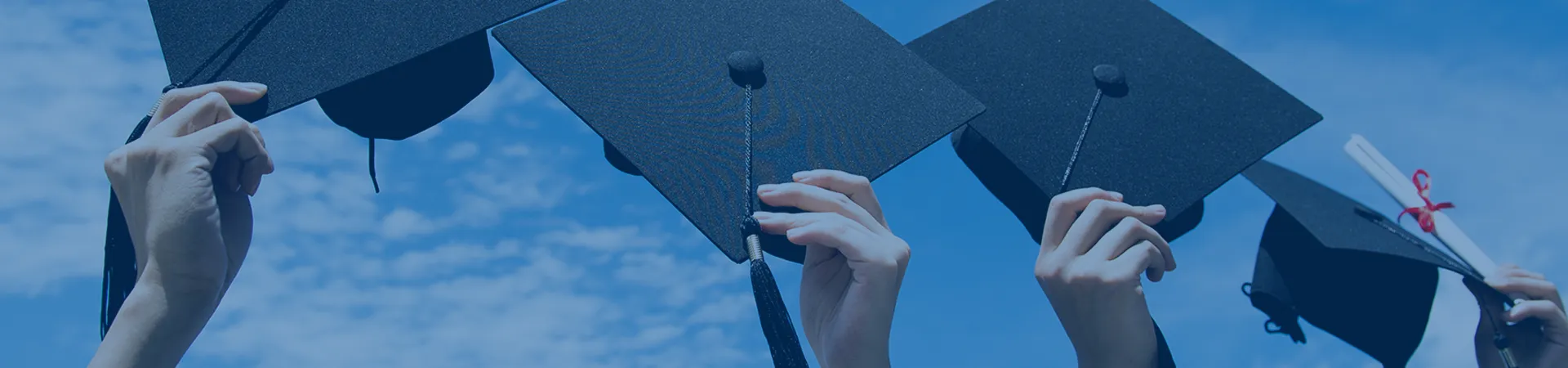 Graduate students holding graduation hats