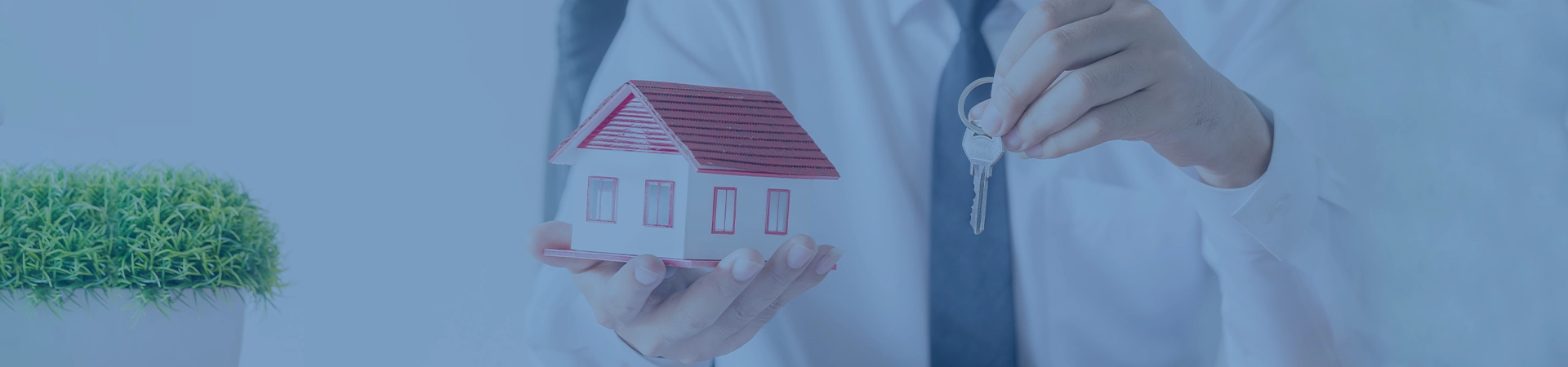 Real Estate Agent with House Model and keys