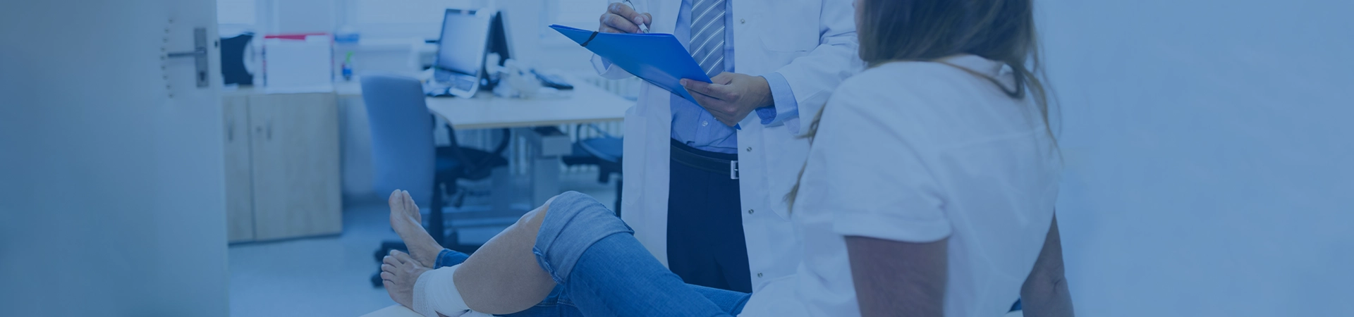 Doctor giving treatment to a girl with injured leg
